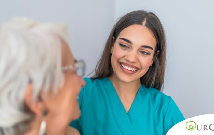 A caregiver smiles with an older client showing the results of successfully starting a new caregiving job.