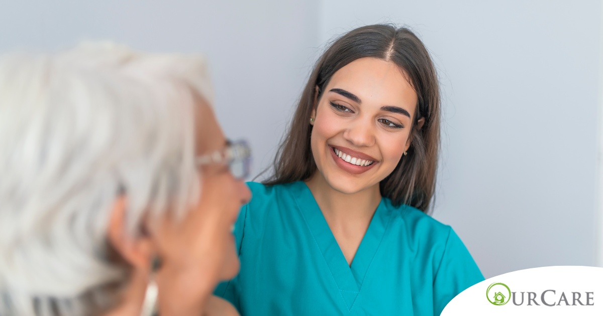 A caregiver smiles with an older client showing the results of successfully starting a new caregiving job.