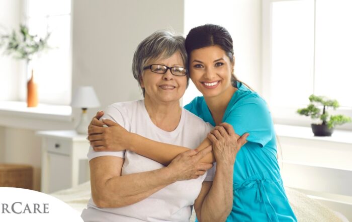 A caregiver hugs an older client, representing how a trustworthy caregiver cares for clients.