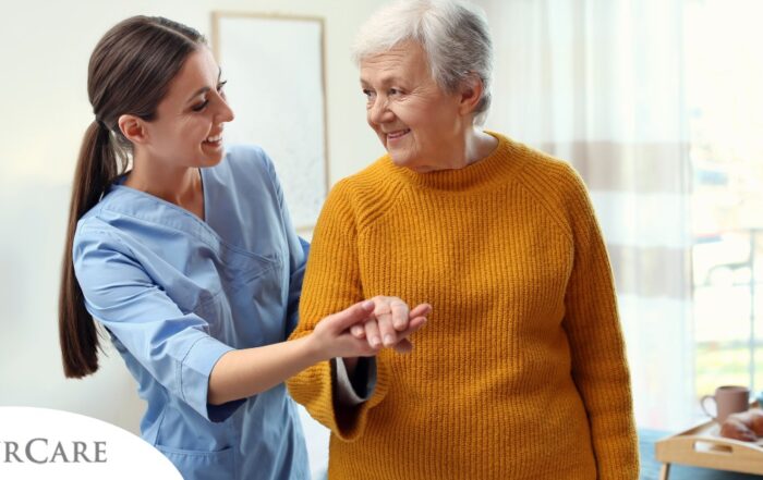 A caregiver helps a client get around, demonstrating one of the job duties of a caregiver.