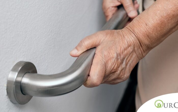An older adult uses a grab bar representing one of the home modifications that is helpful for fall prevention for elderly adults.