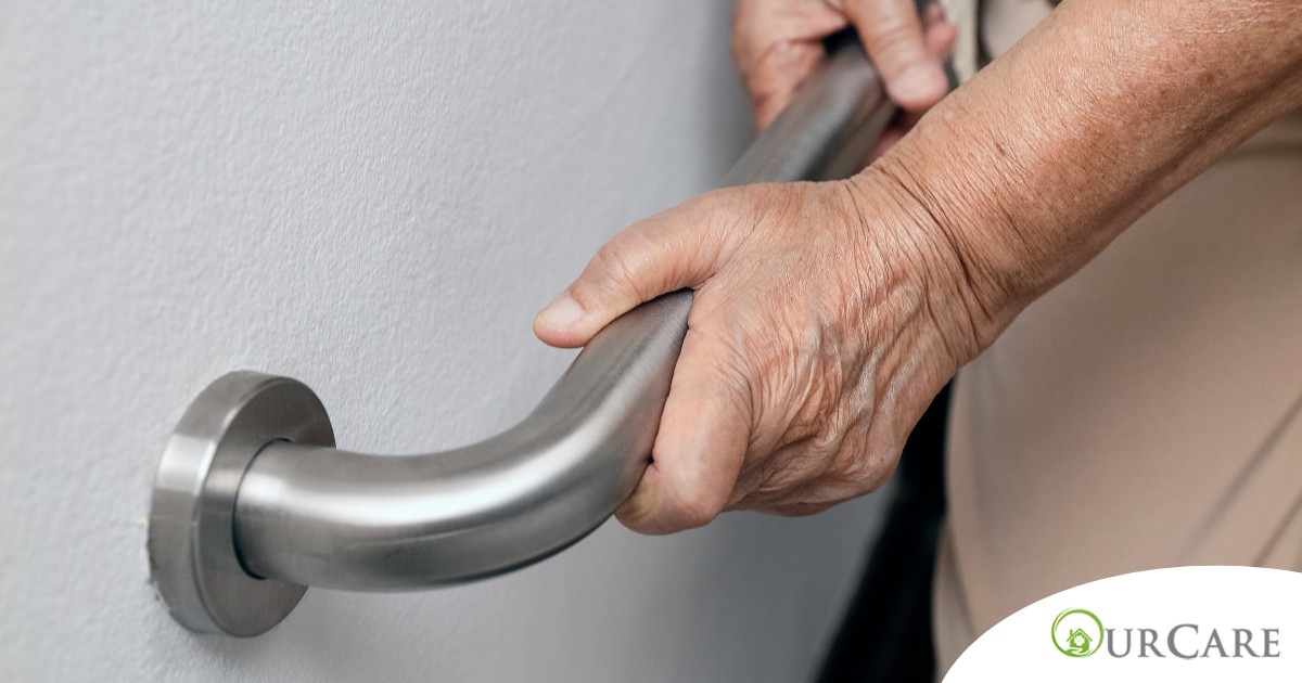 An older adult uses a grab bar representing one of the home modifications that is helpful for fall prevention for elderly adults.