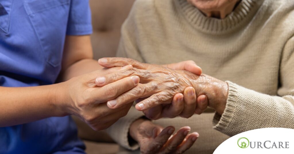 A care provider examines an older adult’s fingers, representing what would happen in an examination for rheumatoid arthritis.