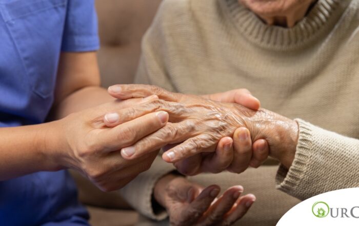 A care provider examines an older adult’s fingers, representing what would happen in an examination for rheumatoid arthritis.