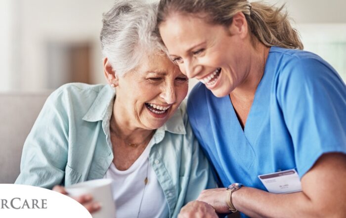 A woman in scrubs laughs with a senior woman, representing how caregiving can be a great career choice.