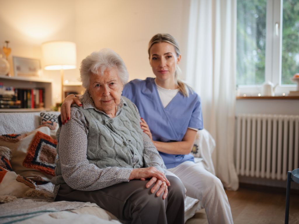 Caregiver providing companion care and emotional support to an elderly woman at home in Temple Terrace