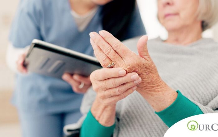 A caregiver provides in home care services to a senior with arthritis