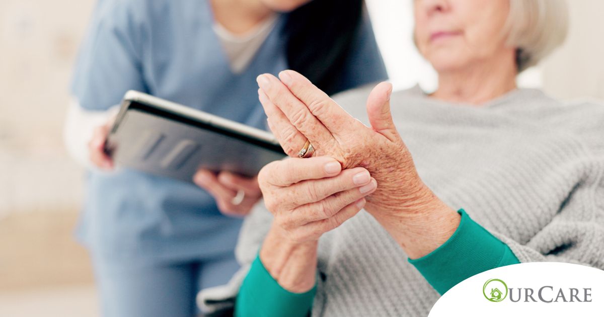A caregiver provides in home care services to a senior with arthritis