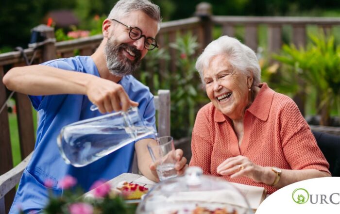 A caregiver applies summer Caregiving Tips including helping a senior stay hydrated.